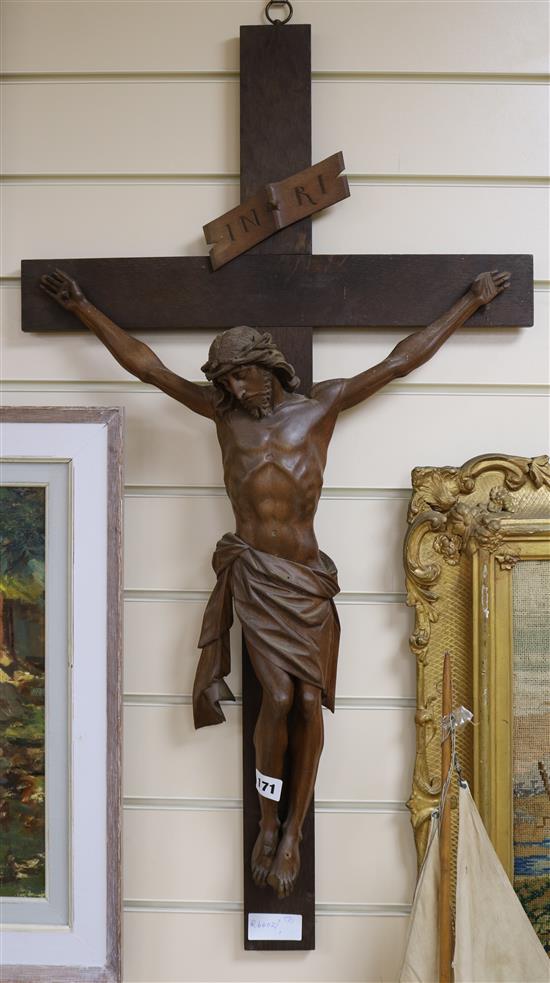 A carved crucifix and a religious petit point